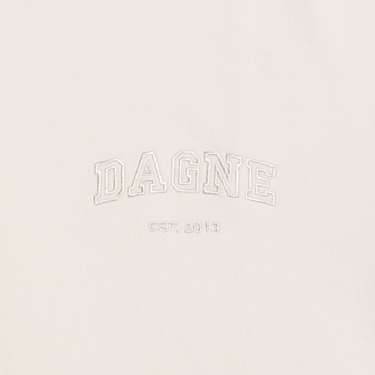 Dagne Dover T-Shirt logo closeup in moonbeam.