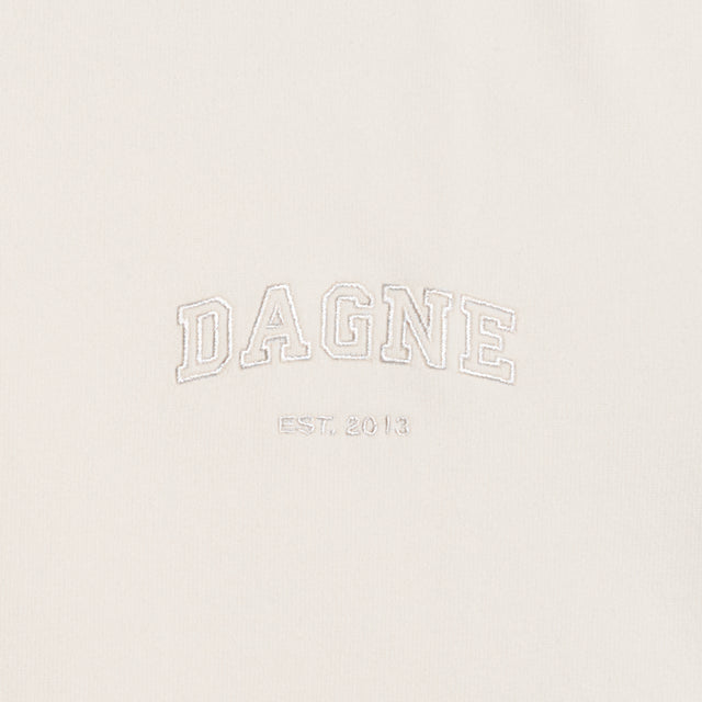Dagne Dover T-Shirt logo closeup in moonbeam.