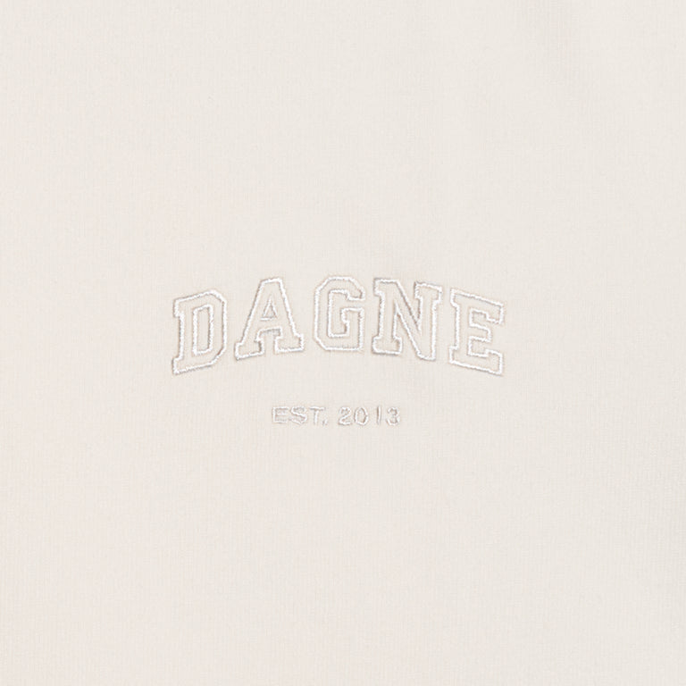 Dagne Dover T-Shirt logo closeup in moonbeam.