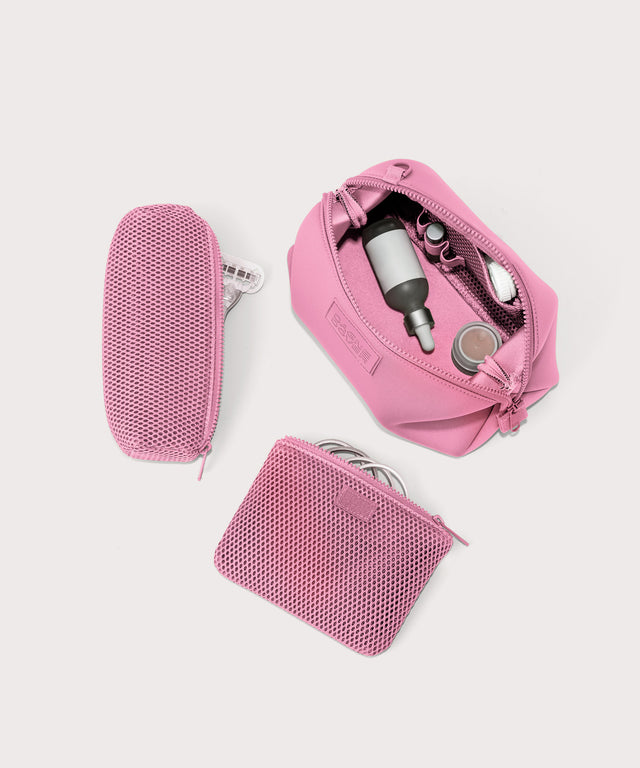 Dagne Dover Large Hunter Toiletry Bag in a true bubble gum pink unzipped and seen from above with the removable air mesh pouch alongside it.