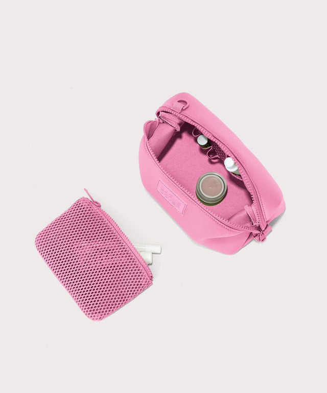 Dagne Dover Small Hunter Toiletry Bag in a true bubble gum pink unzipped and seen from above with the removable air mesh pouch alongside it.