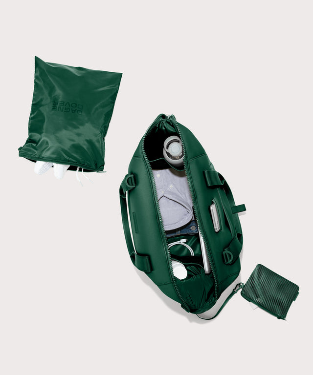 Large Landon Carryall in a saturated, jewel-toned deep green with bold blue undertones. unzipped, top down view. 
