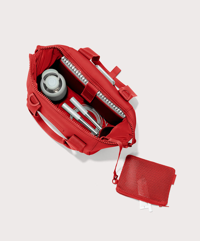 Dagne Dover Small Landon Carryall in a fiery, saturated red leaning toward orange unzipped, top down view. 