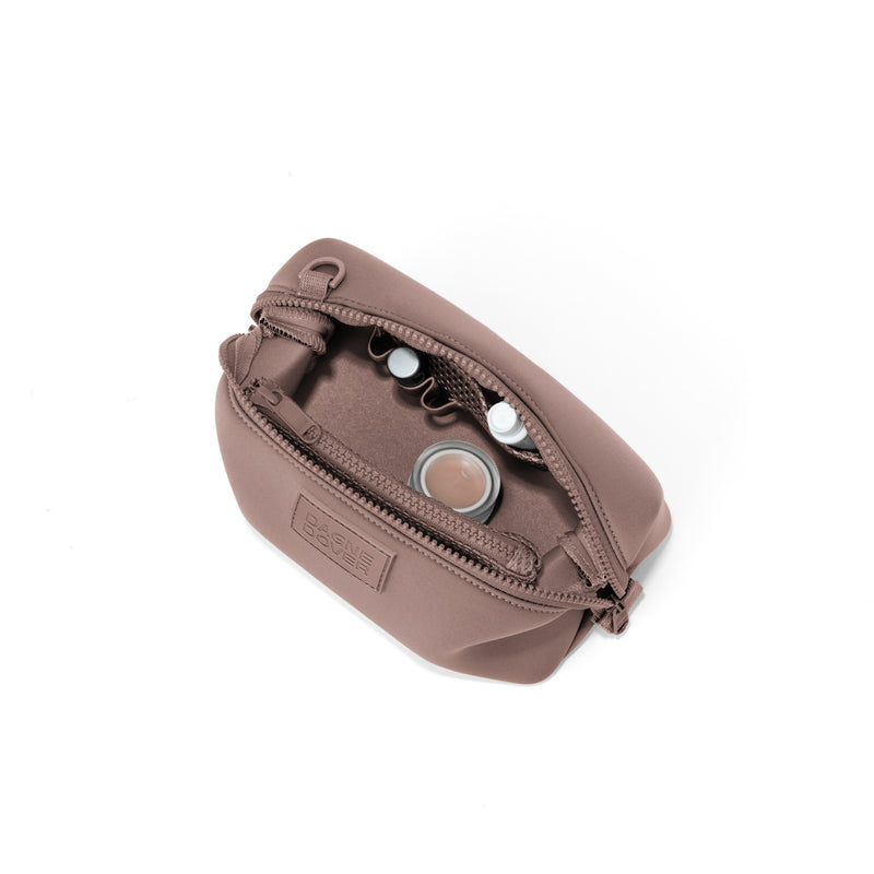 Dagne Dover Small Hunter Toiletry Bag in pink unzipped and seen from above.