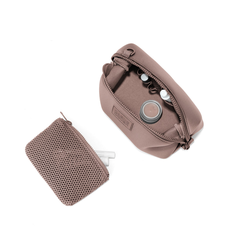 Dagne Dover Small Hunter Toiletry Bag in pink unzipped and seen from above with the removable air mesh pouch alongside it.