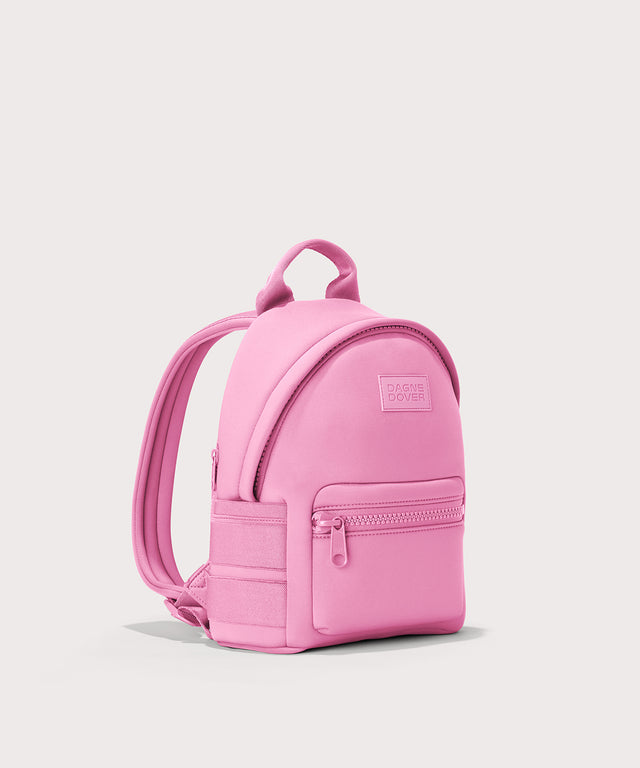 Dagne Dover Small Dakota Neoprene Backpack in a true bubble gum pink seen from an angle.