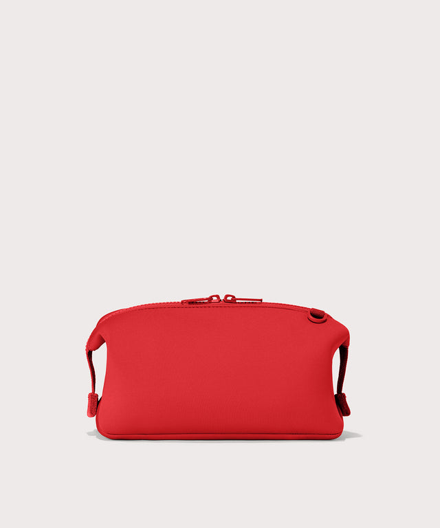 Dagne Dover Large Hunter Toiletry Bag in a fiery, saturated red leaning toward orange seen from the back.