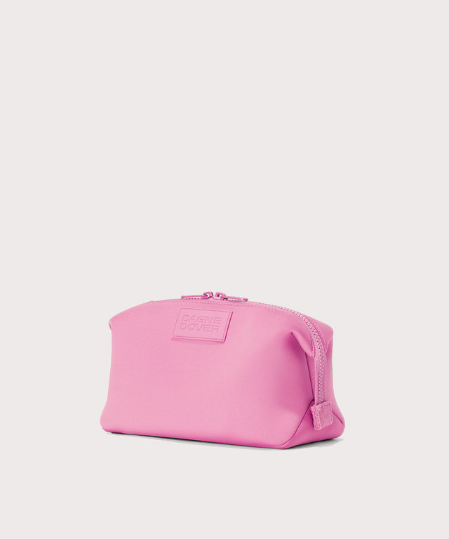 Dagne Dover Large Hunter Toiletry Bag in a true bubble gum pink seen from an angle.