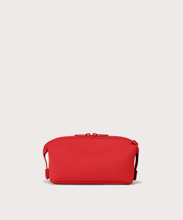 Dagne Dover Small Hunter Toiletry Bag in a fiery, saturated red leaning toward orange seen from the back.