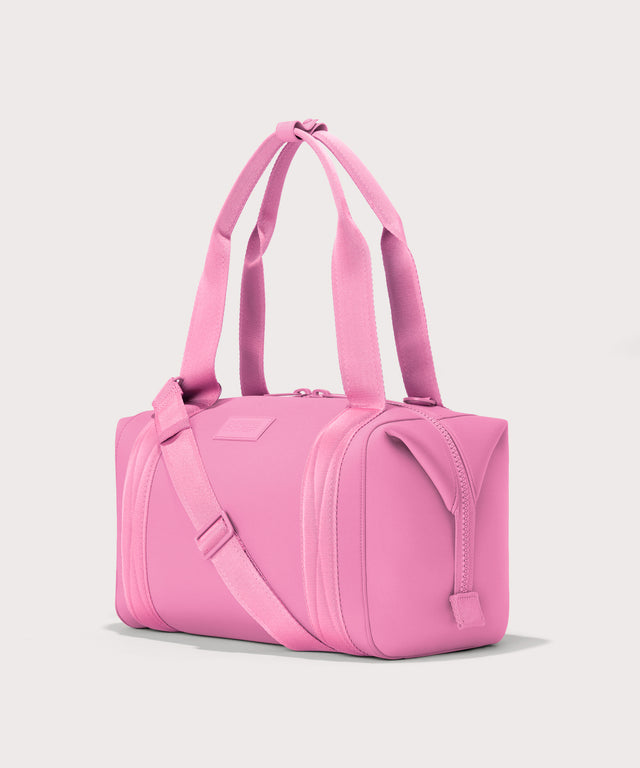 Dagne Dover Medium Landon Carryall in a true bubble gum pink seen from an angle.