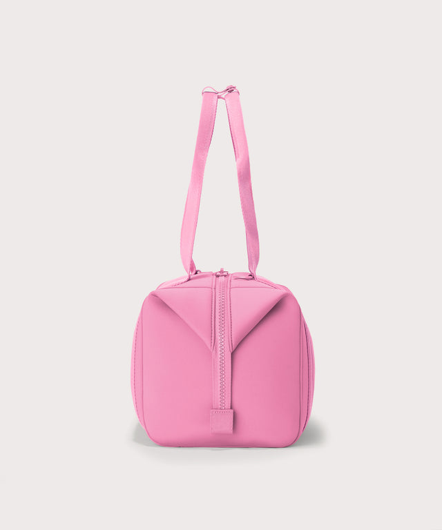 Dagne Dover Medium Landon Carryall in a true bubble gum pink seen from the side.