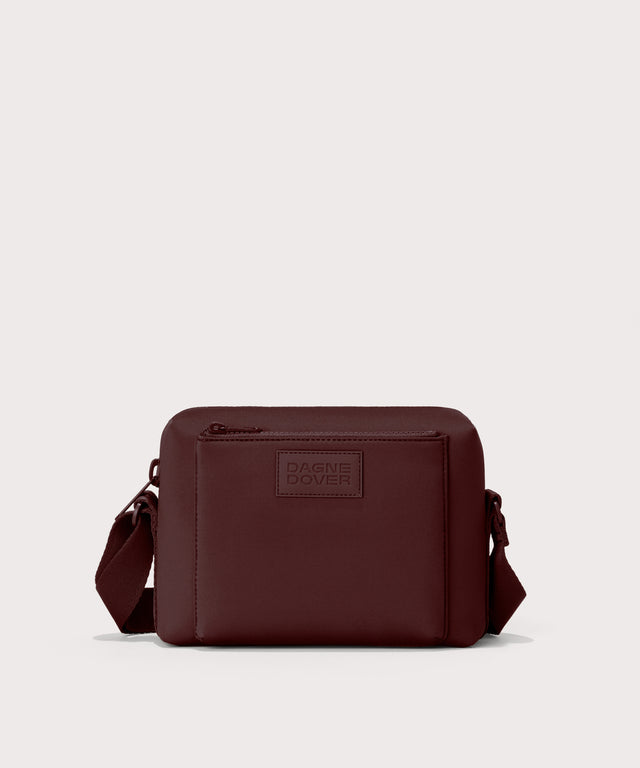 Dagne Dover Micah Crossbody in a deep brown with purple undertones.