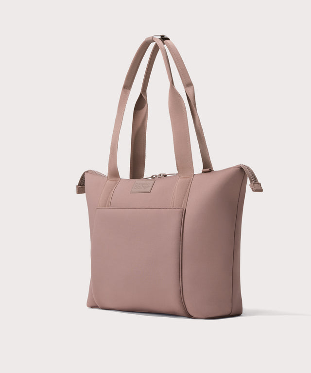 Tote  in a pink seen from the angle view.
