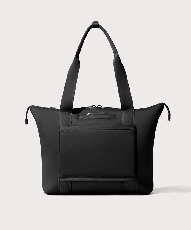 Tote  bag in a  black seen from the back view showing phone pocket.’
