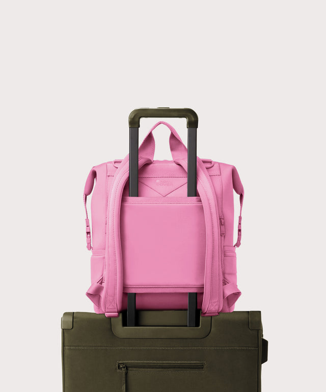 Dagne Dover Large Indi Diaper Backpack in a true bubble gum pink on luggage showing the neoprene luggage sleeve.
