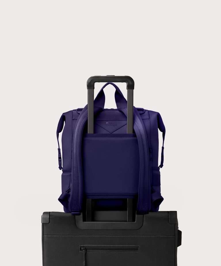 Large Indi backpack in a jewel-toned, deep blue with strong purple undertones. displaying luggage sleeve
