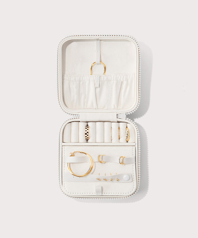 Dagne Dover Large Frankie Jewelry Case in white, seen open from above with jewelry inside the interior compartment.