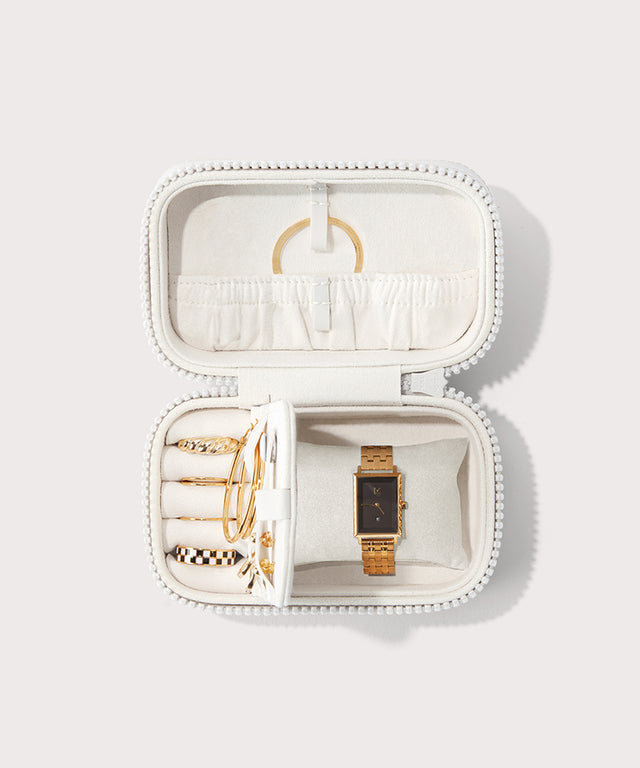 Dagne Dover small Frankie Jewelry Case in white, seen open from above with jewelry inside the interior compartment.