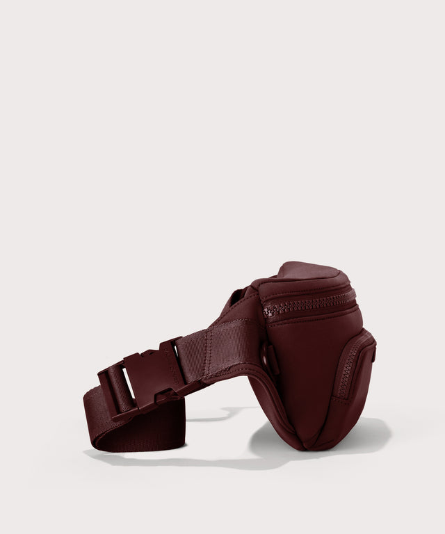 Dagne Dover Jax Large Fanny Pack in a deep brown with purple undertones  seen from the side.