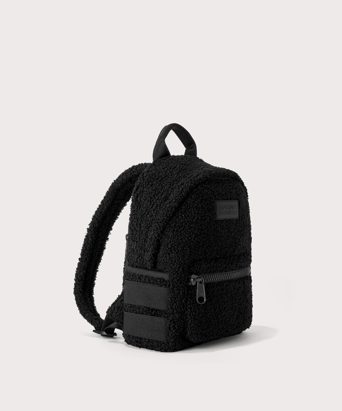 Dakota Small backpack pack in a black.  side angle view  In a black  Faux Shearling  a soft, wool-like plush made with recycled materials
