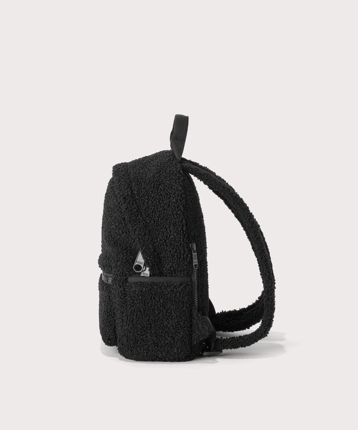 Dakota Small backpack pack in a black, side view  In a  Faux Shearling  a soft, wool-like plush made with recycled materials
