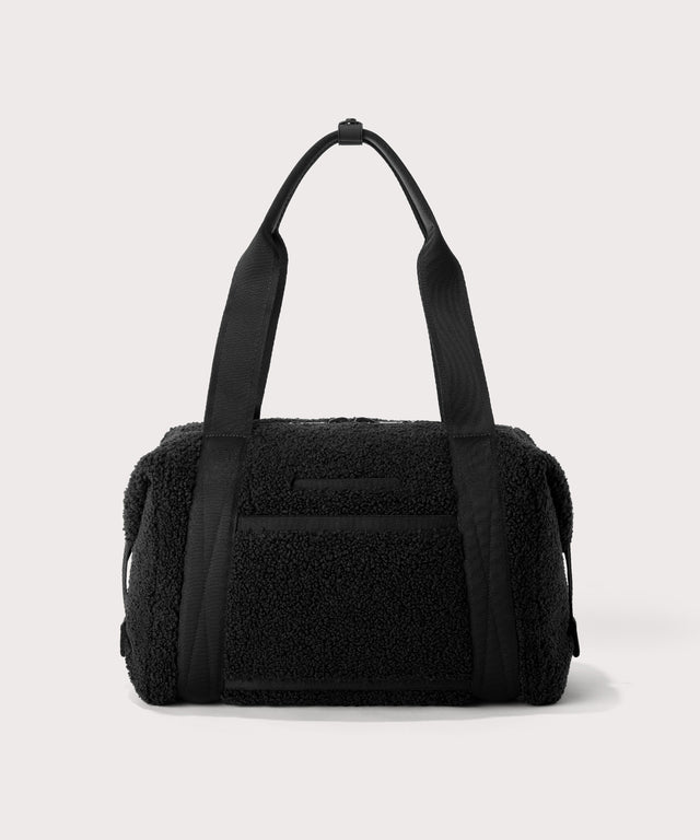 Medium landon carryall in a black.  Back view.  In a  Faux Shearling  a soft, wool-like plush made with recycled materials
