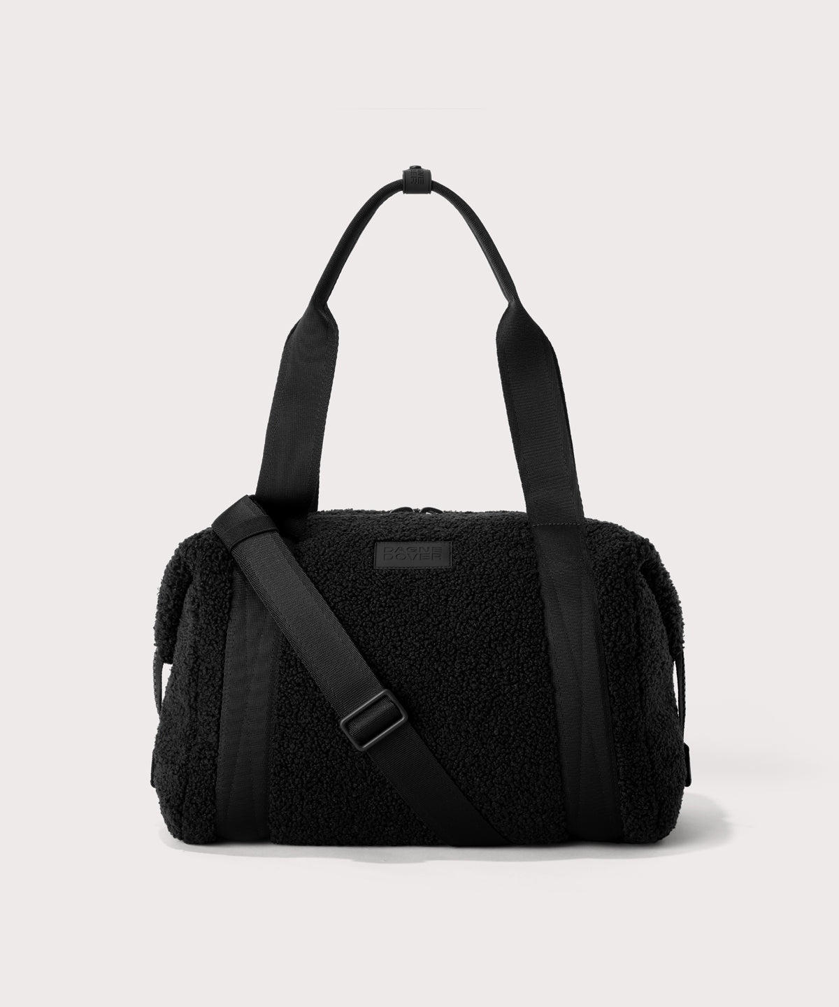 Medium landon carryall in a black. In a  Faux Shearling  a soft, wool-like plush made with recycled materials. front angle. 