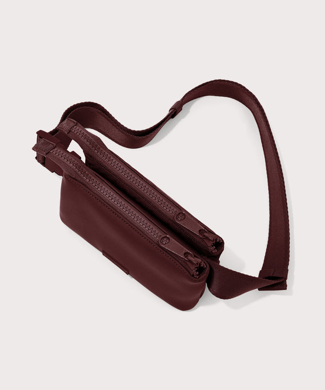 Dagne Dover Bennie Sling in a deep brown with purple undertones seen from above with both pouches zipped.