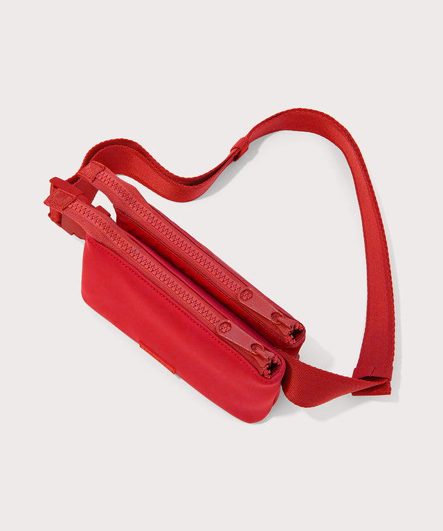 Dagne Dover Bennie Sling in a fiery, saturated red leaning toward orange seen from above with both pouches zipped.