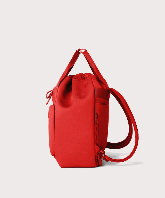 Dagne Dover Rhys Backpack in a fiery, saturated red leaning toward orange seen from the side.
