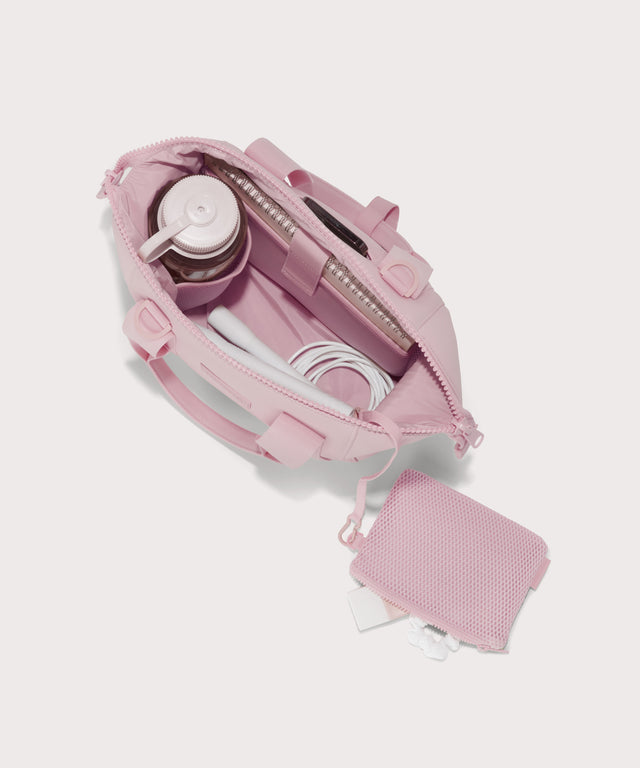  Small Landon Carryall in a cool, powdery pink with soft grey undertones unzipped, top down view. 
