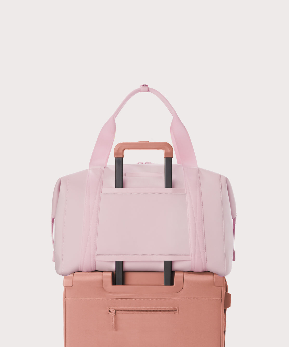 Extra large Landon Carryall in a cool, powdery pink with soft grey undertones displaying luggage sleeve
