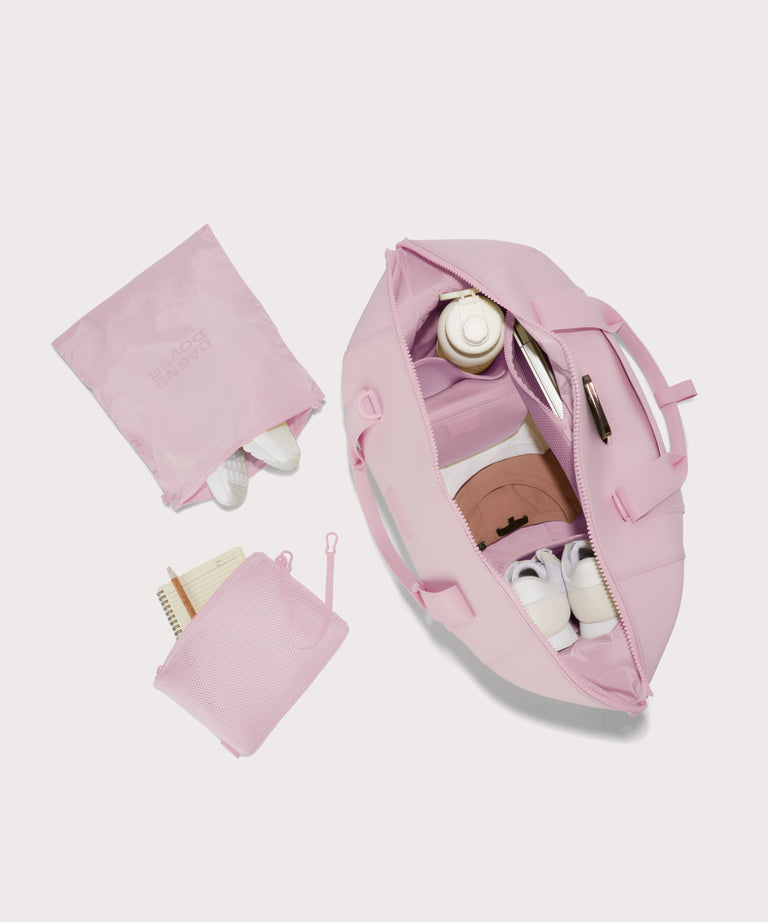 Extra large Landon Carryall in a cool, powdery pink with soft grey undertones unzipped, top down view. 
