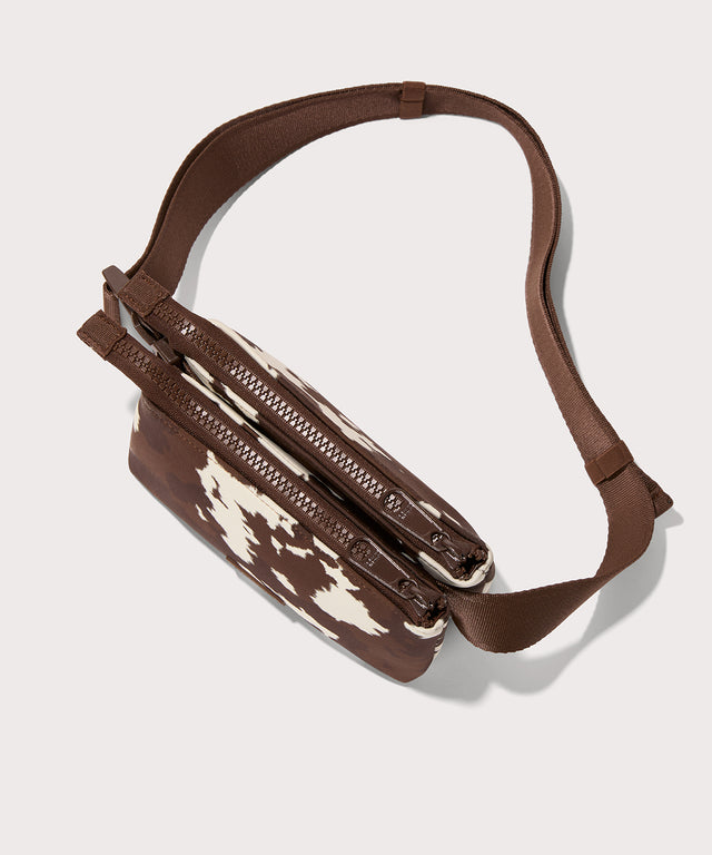 Dagne Dover Bennie Sling in a cow print as seen from the topdown view.