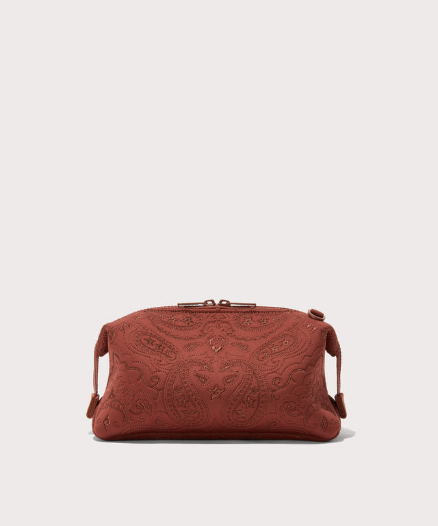 Dagne Dover Large Hunter Toiletry Bag in a rich, warm brown with an embroidered paisley print seen from the back.