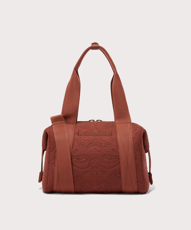 Dagne Dover Small Landon Carryall in a rich, warm brown with an embroidered paisley print seen from the back.