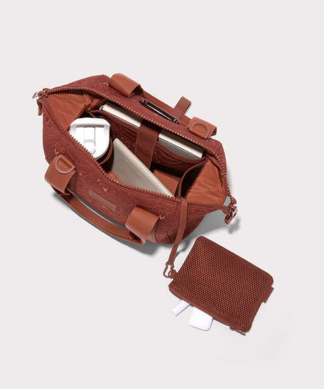 Dagne Dover Small Landon Carryall in a rich, warm brown with an embroidered paisley print unzipped, top down view.