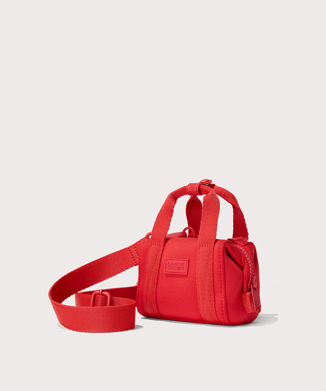 Dagne Dover Micro Landon Crossbody in a fiery, saturated red leaning toward orange seen from an angle.