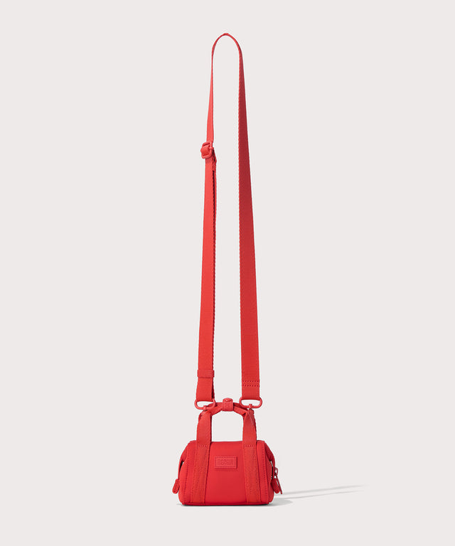 Dagne Dover Micro Landon Crossbody in a fiery, saturated red leaning toward orange with the crossbody strap.