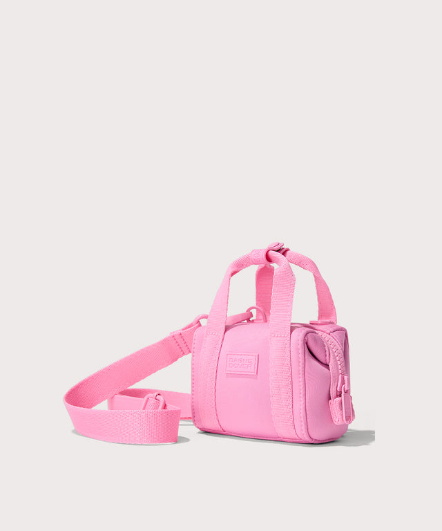 Dagne Dover Micro Landon Crossbody in a true bubble gum pink seen from an angle.
