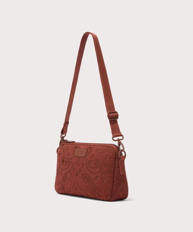 Dagne Dover Nora Shoulder Bag in a rich, warm brown with an embroidered paisley print seen from an angle.