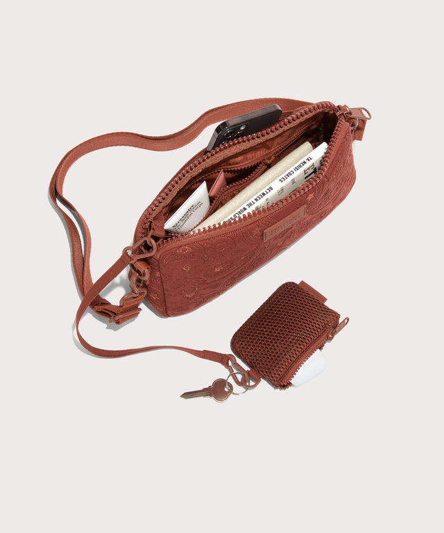 Dagne Dover Nora Shoulder Bag in a rich, warm brown with an embroidered paisley print unzipped, top down view.
