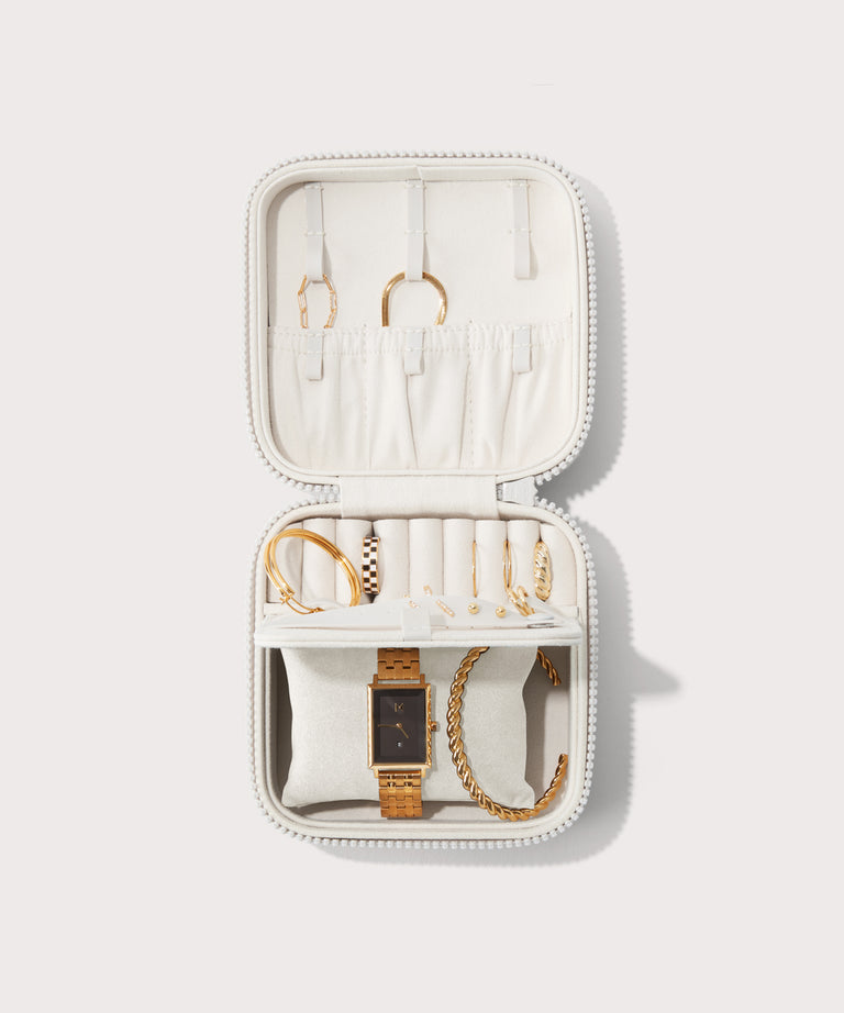 Dagne Dover Large Frankie Jewelry Case in white, seen open from above with jewelry inside the interior compartment.
