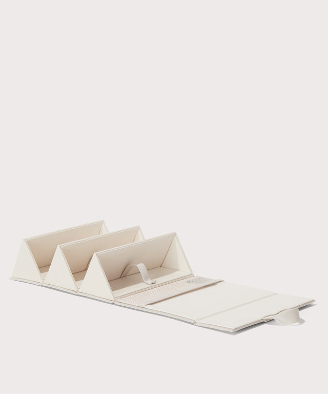 Dagne Dover Remi foldable glasses holder in white, unfolded.
