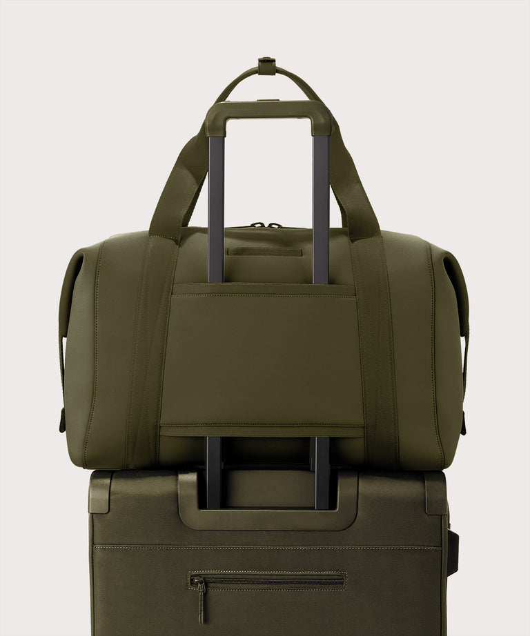 Extra large Landon Carryall in dark green displaying luggage sleeve
