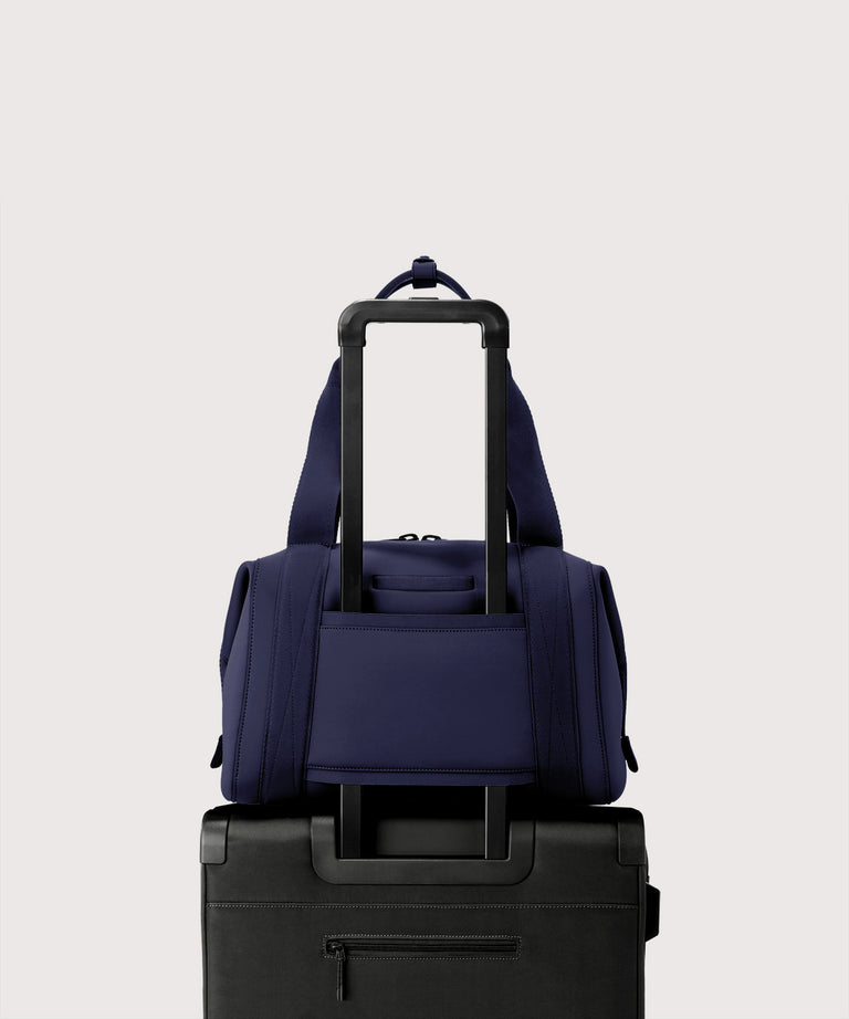 Large Landon Carryall in dark blue displaying luggage sleeve
