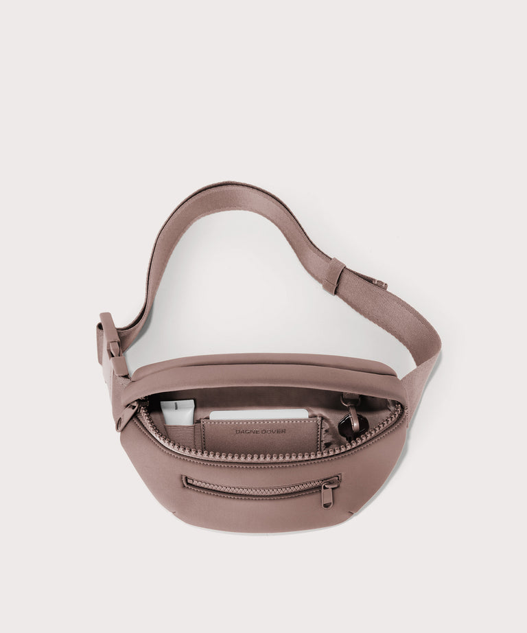 Dagne Dover Ace Fanny Pack in  pink  unzipped, exposing the interior pockets
