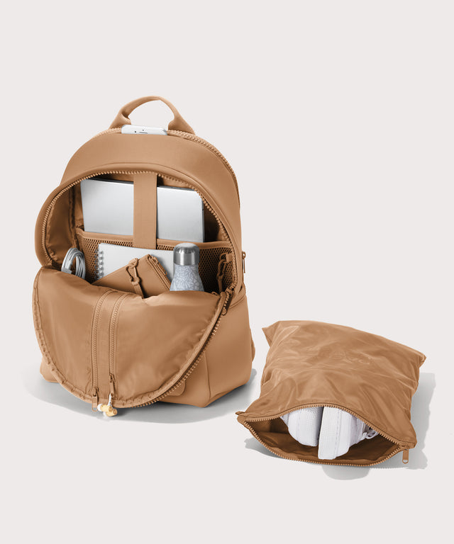 Dagne Dover large Dakota Neoprene Backpack in camel unzipped, showing the interior pockets and shoe bag.