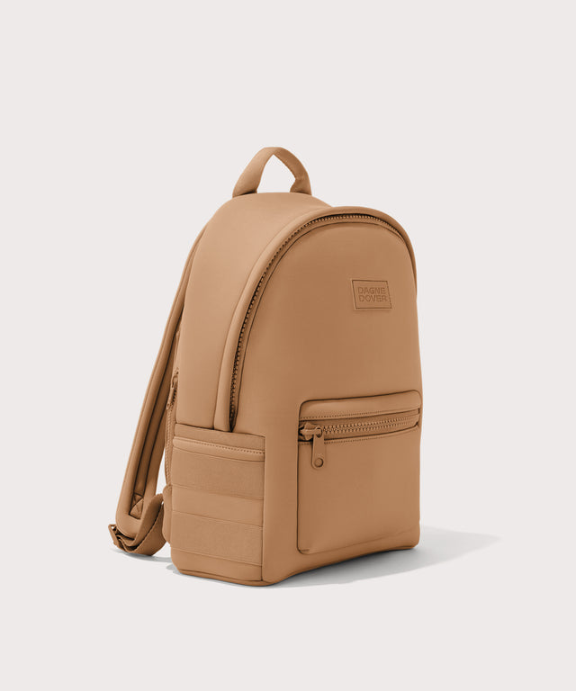 Dagne Dover medium Dakota Neoprene Backpack in camel brown seen from an angle.
