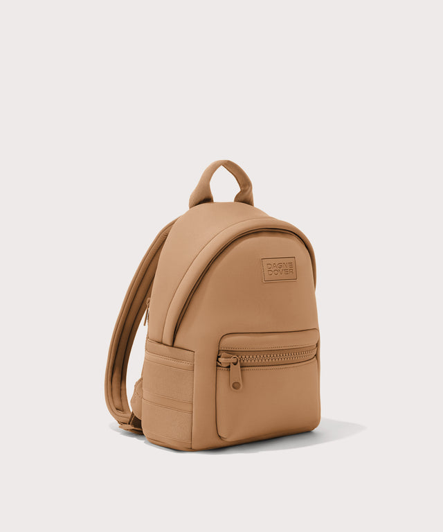 Dagne Dover small Dakota Neoprene Backpack in camel seen from an angle.
